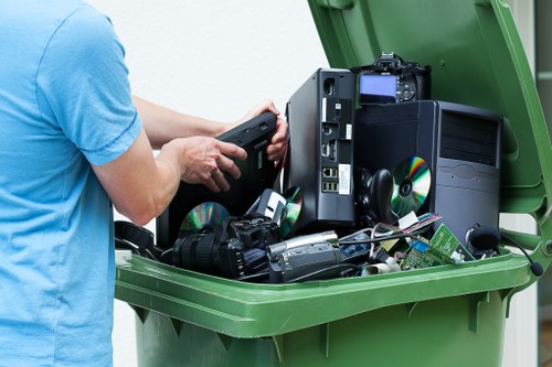 Recycling materials being loaded into an enclosed skip