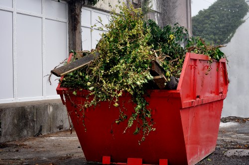 Mini skip being loaded with household waste